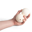 Two white Mr Babache russian juggling balls in hand