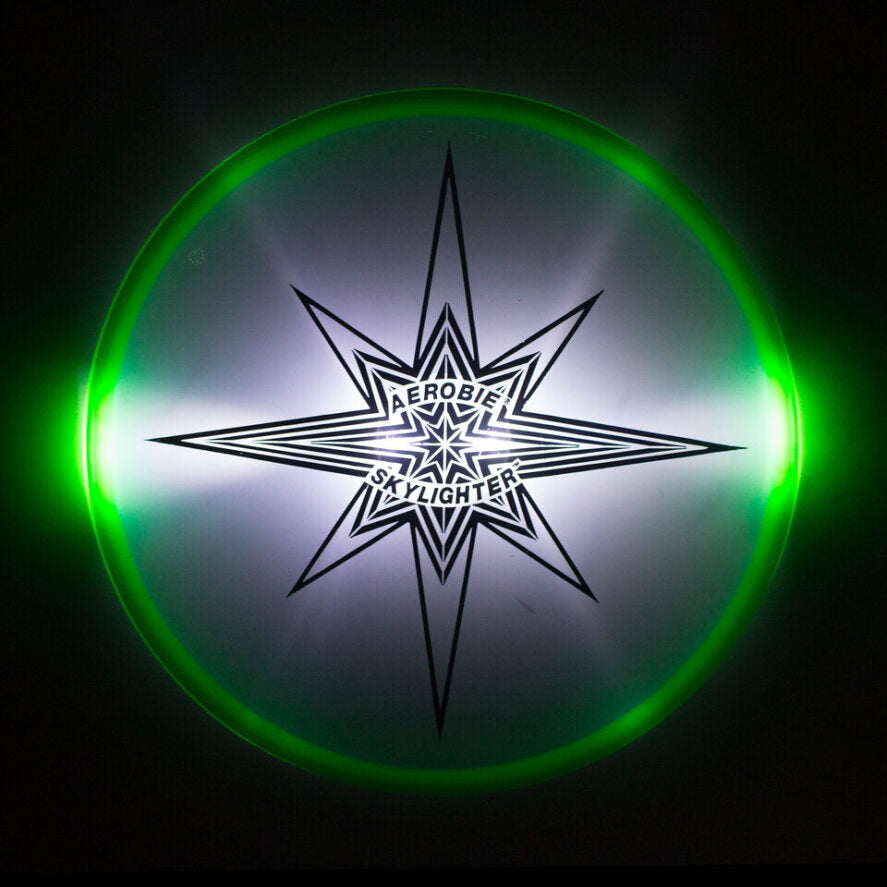 Aerobie skylighter green lit on black background